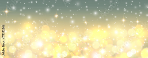 Christmas background, golden blurred lights, snowflakes and glittering bokeh 