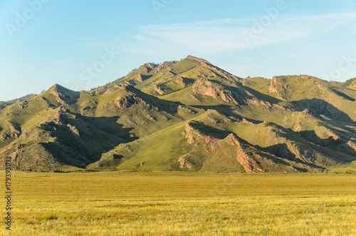 Sunny summer landscape, hills, forest, blue sky.