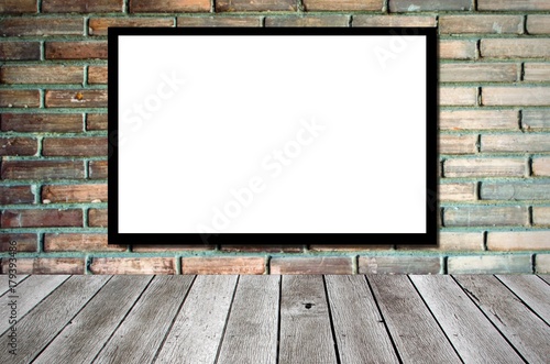 blank advertising billboard or wide screen television on old vintage brick wall background and wooden shelf or desk, copy space for display of product presentation, commercial and marketing concept © Vittaya_25