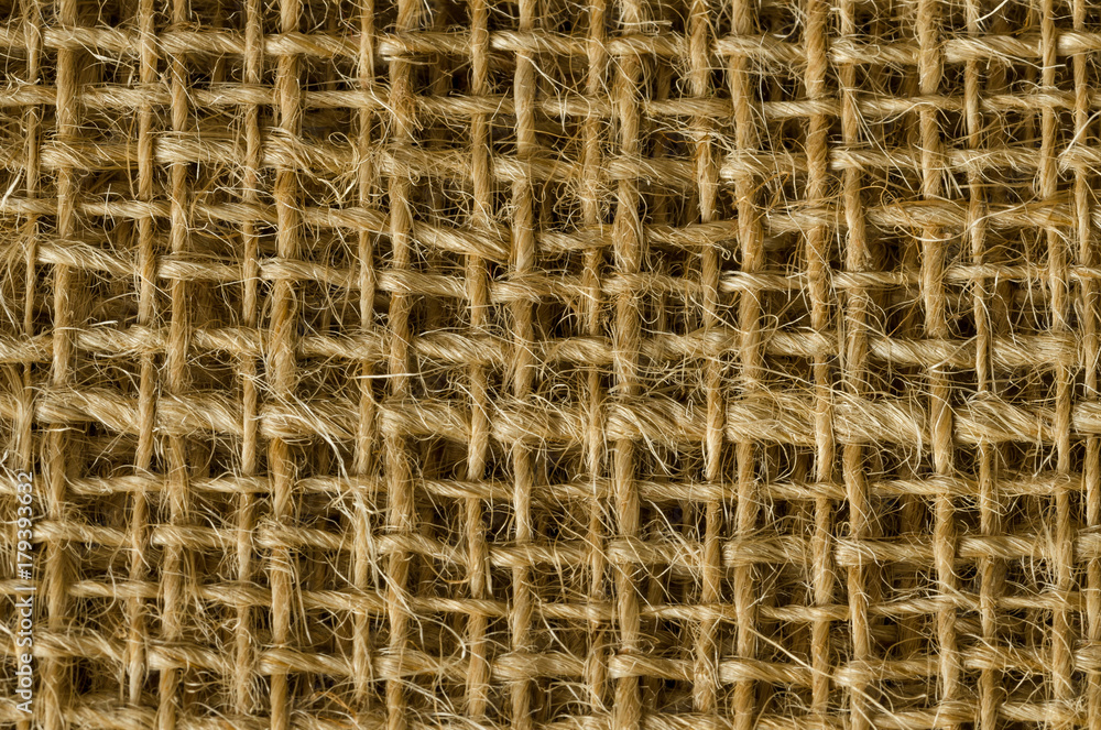 Jute fabric layers from above. Coarse brown threads woven to a