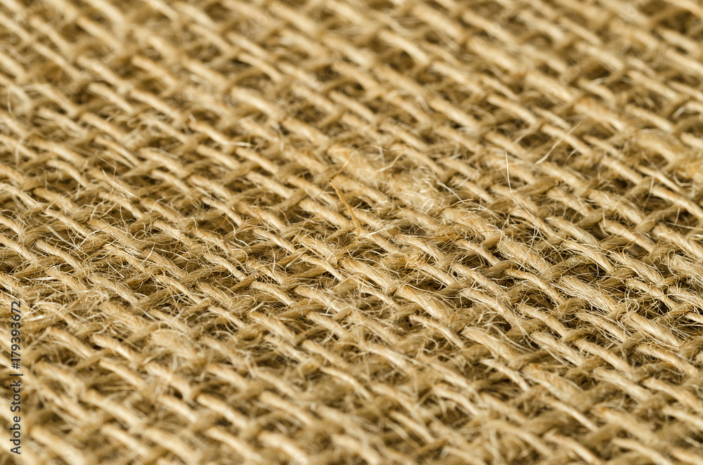 Jute fabric layers diagonal view. Coarse brown threads woven to