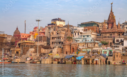 Varanasi city with old architectural buildings and ancient temples along the Ganges river ghat as viewed from a boat. © Roop Dey