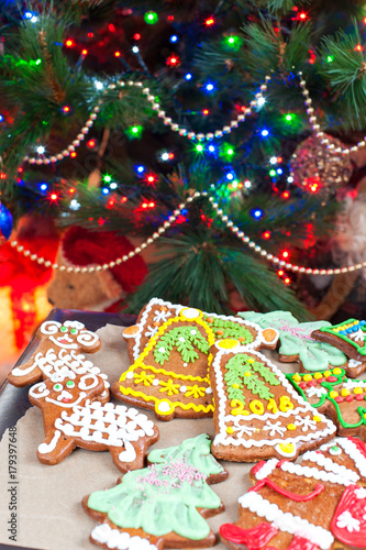 Homemade christmas tree shape gingerbread cookies on illuminated festive background