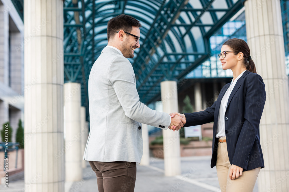 Young business people shaking hands 