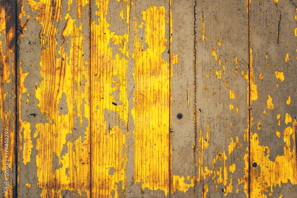 Obraz premium Yellow weather worn wooden texture with paint peeling off