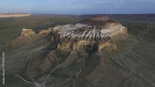 Flying a drone over the mountain Sherkala. Sunset photo