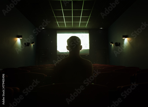 One man sitting in empty cinema hall