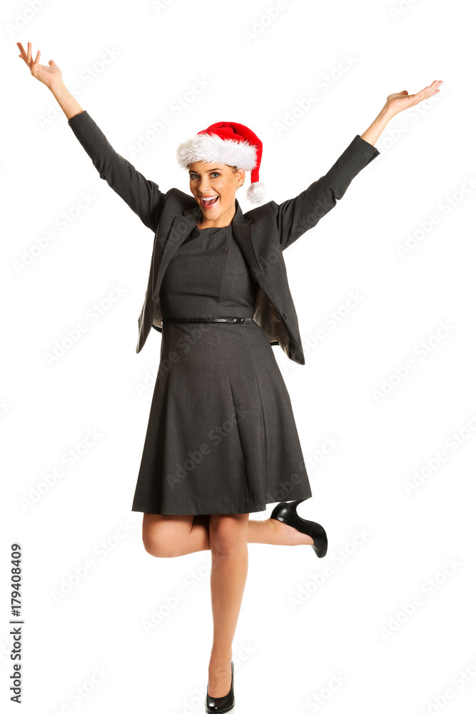 Happy businesswoman wearing christmas hat Happy businesswoman wearing christmas hat