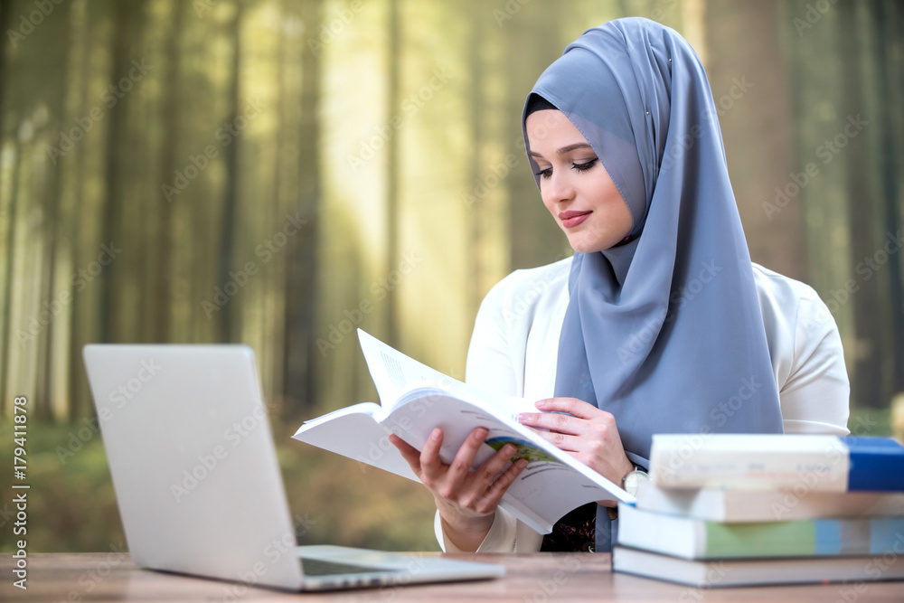 Pretty woman wearing hijab in front of laptop Pretty woman wearing hijab in front of laptop