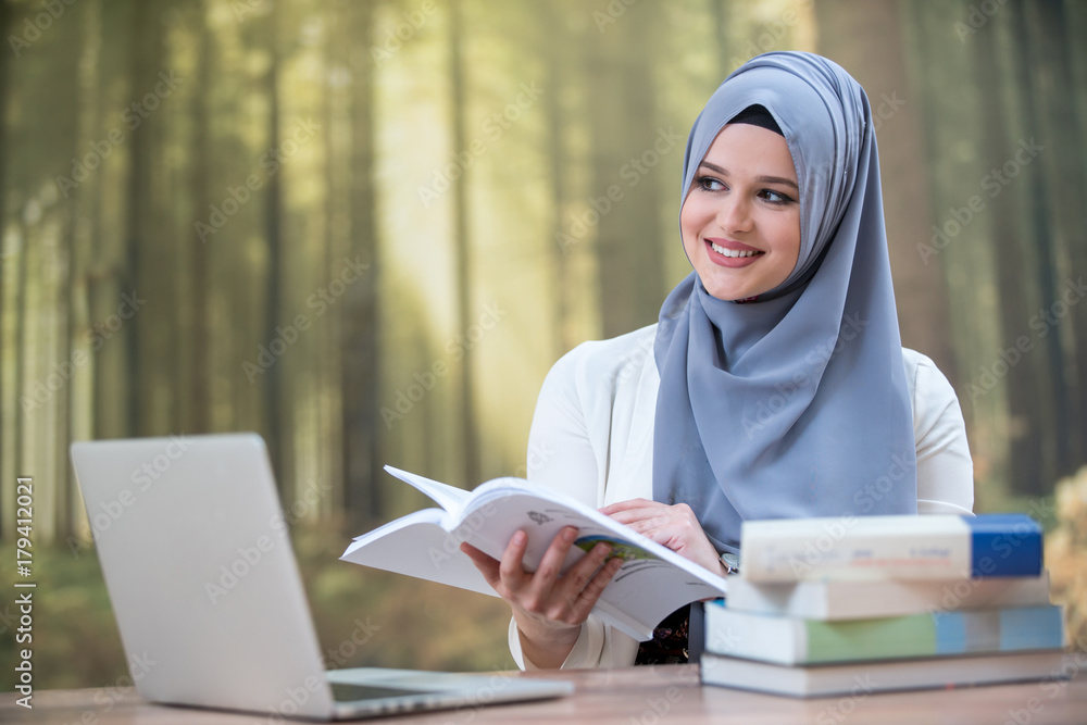 Pretty woman wearing hijab in front of laptop Pretty woman wearing hijab in front of laptop