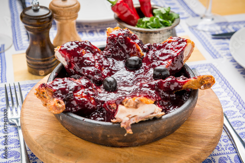 Grilled meat with pomegranate seed on white plate