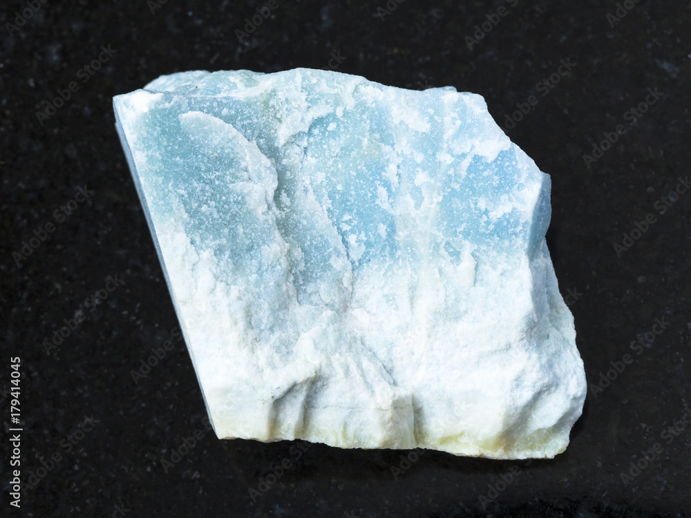 raw blue Violane stone on dark background