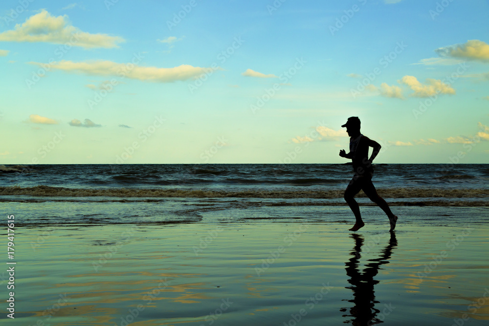 silhouette man run on beach