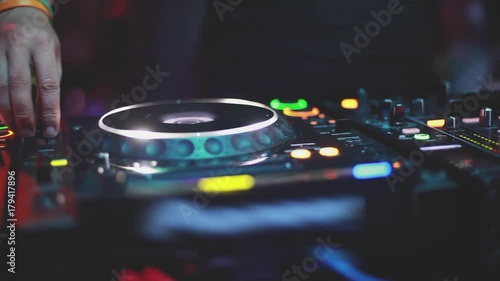 Close up of DJ plays music mixing and scratching on turntable music equipment. 1920x1080