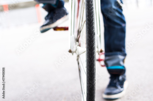 modern man rides a fixie bicycle in the street