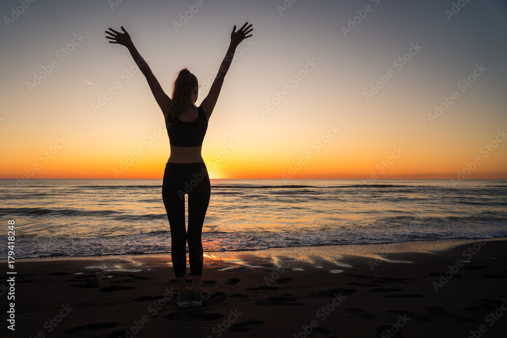 girl on the sea during sunset. Fitness and healthy lifestyle
