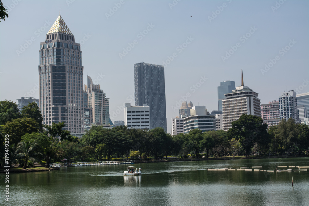 Fototapeta premium Lumphini Park is a park in Bangkok, Thailand that offers rare open public space, trees, and playgrounds in the capital and contains an artificial lake are a popular for morning and evening joggers