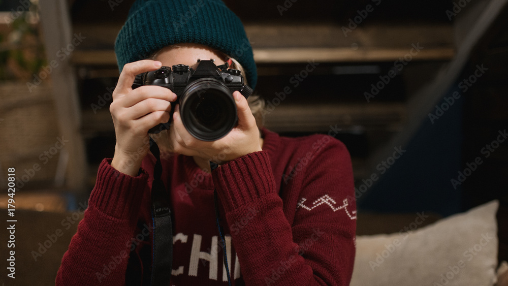 Young hipster woman making photos with photo camera