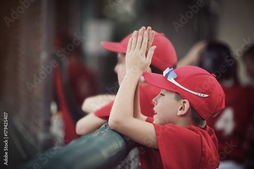 Εκτύπωση καμβά Baseball team in the dugout, cheering for their team, shallow focus, focus on ha
