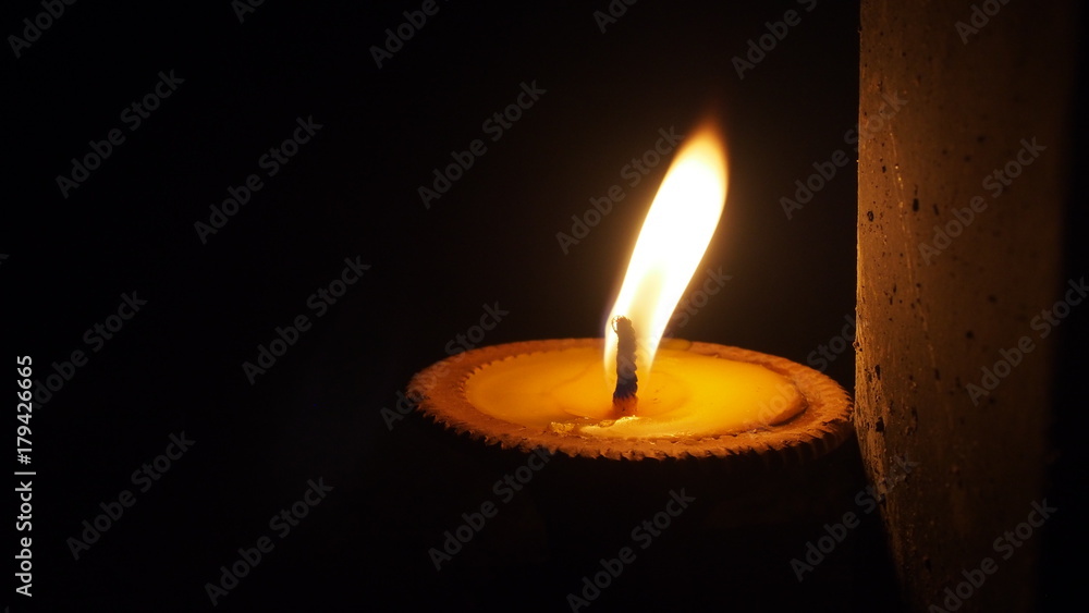 burning flat candle at night isolated on dark background burning flat candle at night isolated on dark background