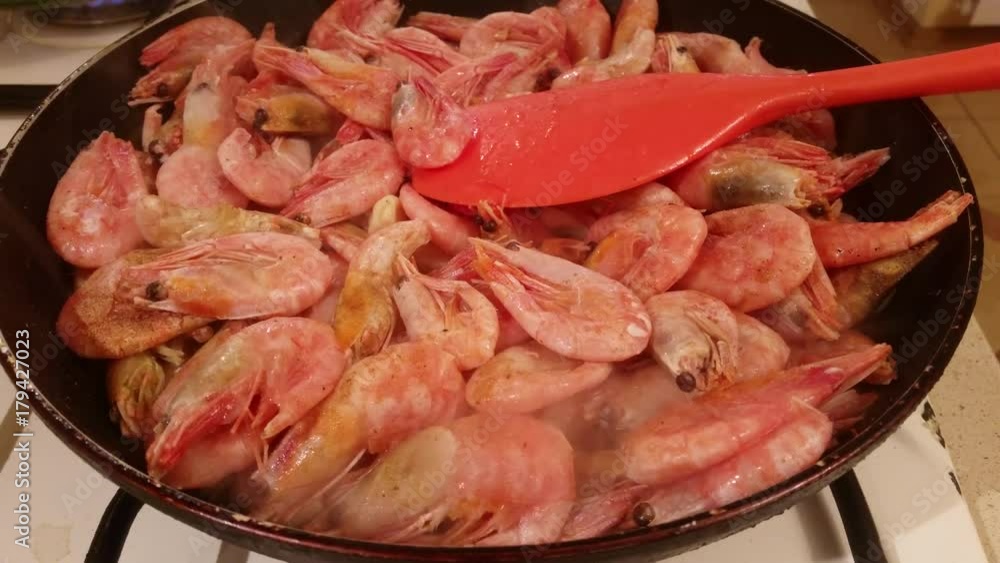 Delicious medium-sized shrimps with the heads fried on a pan with garlic and spices
Delicious medium-sized shrimps with the heads fried on a pan with garlic and spices