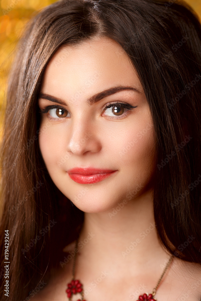 Golden beautiful fashion woman, model with shiny healthy long volume hair. Waves curls updo volume hairstyle. Hair Salon.Girl with luxurious haircut on gold background Golden beautiful fashion woman, model with shiny healthy long volume hair. Waves curls updo volume hairstyle. Hair Salon.Girl with luxurious haircut on gold background