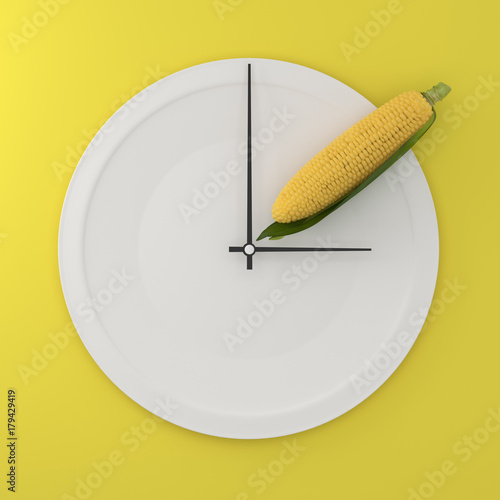Top view of corn on white round plate in a form of clock on yellow background. Food health concept diet decision. minimal food creative arrangement,