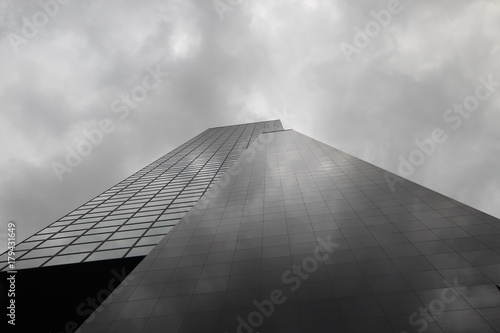Skyscraper in Rotterdam with clouds reflection