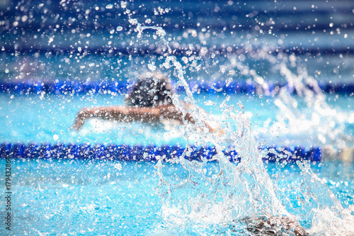 Blurry background of splash drop water on swimming race. © suwanphoto