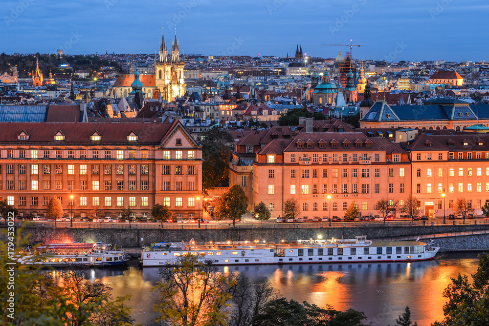 Prague, Czech Republic - October 6, 2017: Beautiful evening roof view on Tyn Church, Vltava river and  Old Town Square, Prague, Czech Republic. The Church of Our Lady Before Tyn.