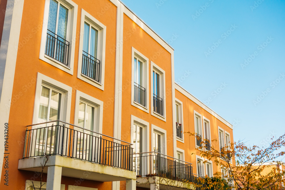 red facaded townhouse with white details red facaded townhouse with white details
