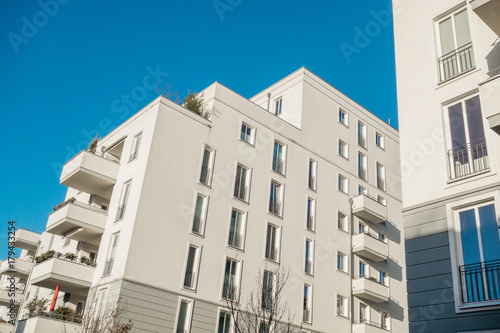 big white apartment complex with darken sky