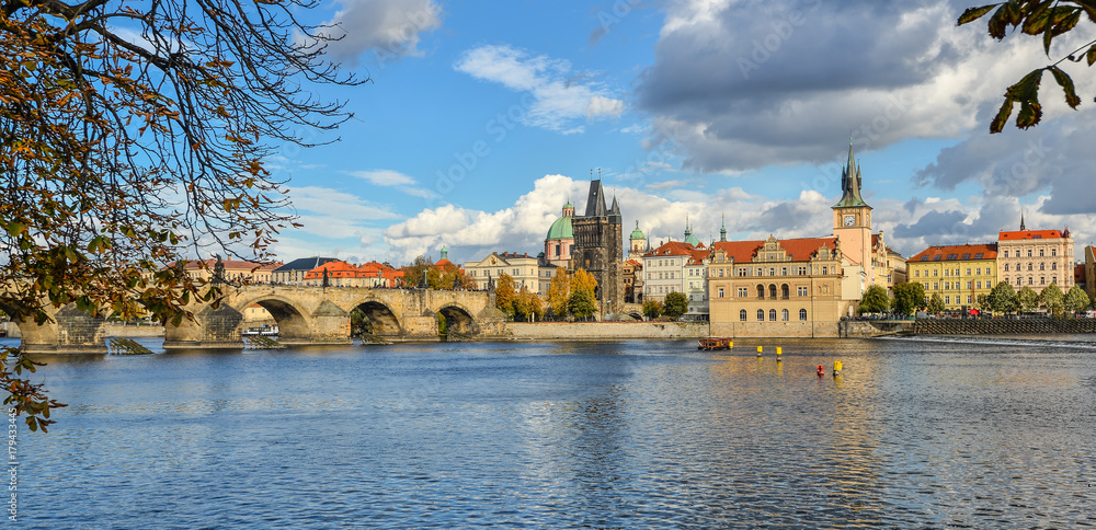 Prague, Czech Republic - October 8, 2017: Beautiful autumn view on Vltava river, Charles Bridge and  Old Town of Prague, Czech Republic. Prague city center and dramatic skyline 