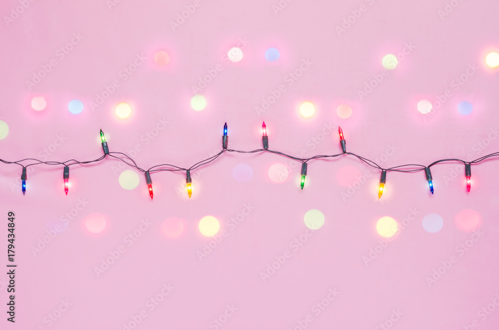 lights bulbs on string with bokeh light in red, blue & green colour on pink