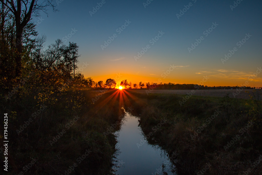 Sunset Over a Creek and Field