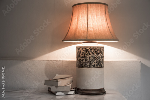 lamp with books on the table photo