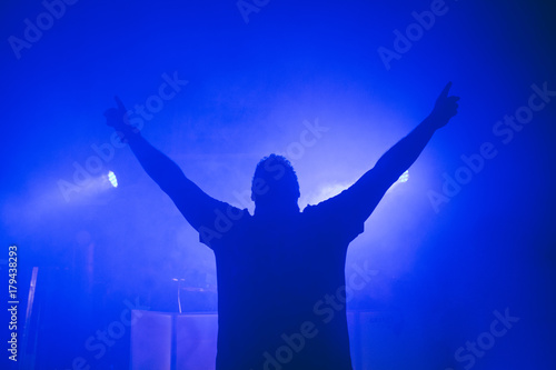 DJ hands up at night club party