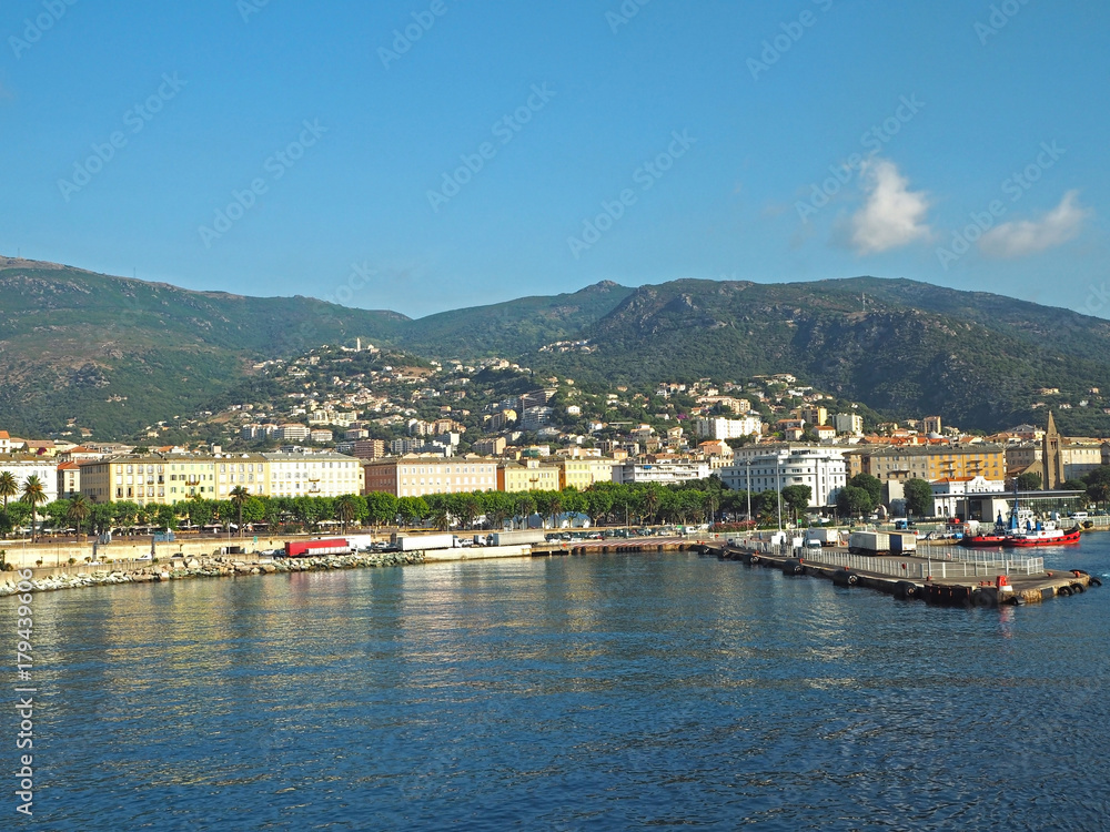 FRANCE, CORSE, BASTIA, JUNE 23, 2017: View from sea on Bastia port and surrounding hills and blue sky background