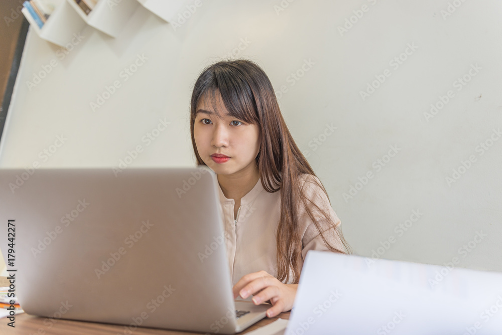 Office lady working on laptop at workplace Office lady working on laptop at workplace