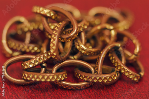 Aureate chain close-up on a red background