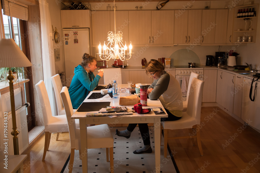 mother with her daughter eat at dinner in the kitchen mother with her daughter eat at dinner in the kitchen