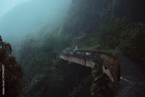 woman enjoying view from abandoned bridge