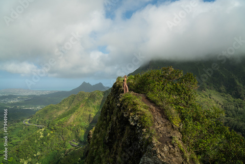 woman standing on mountain ridge