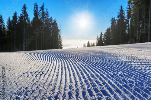 Obraz na plátně Fresh groomed ski slope in the morning