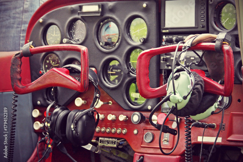 Cockpit of small private lightweight vintage airplane closeup image.