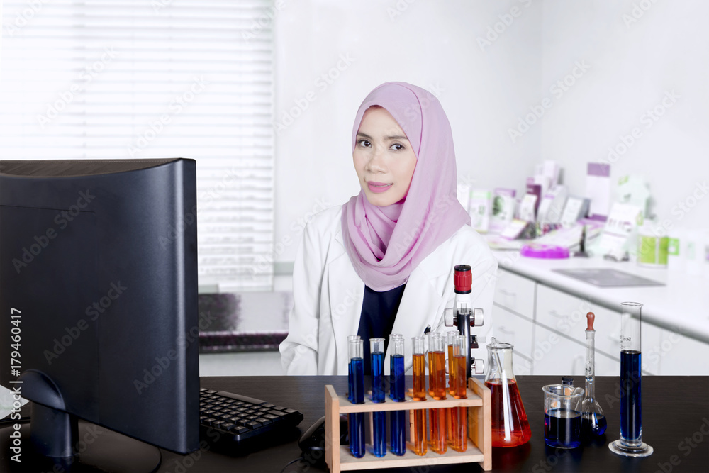 Muslim scientist smiling at camera Muslim scientist smiling at camera