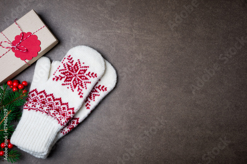 Christmas background with gift boxs, christmas tree, mittens and decorations on dark background. Top view