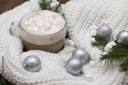 delicious hot cocoa with marshmallows on the Christmas table Christmas balls, fir branches knitted scarf warmth and comfort