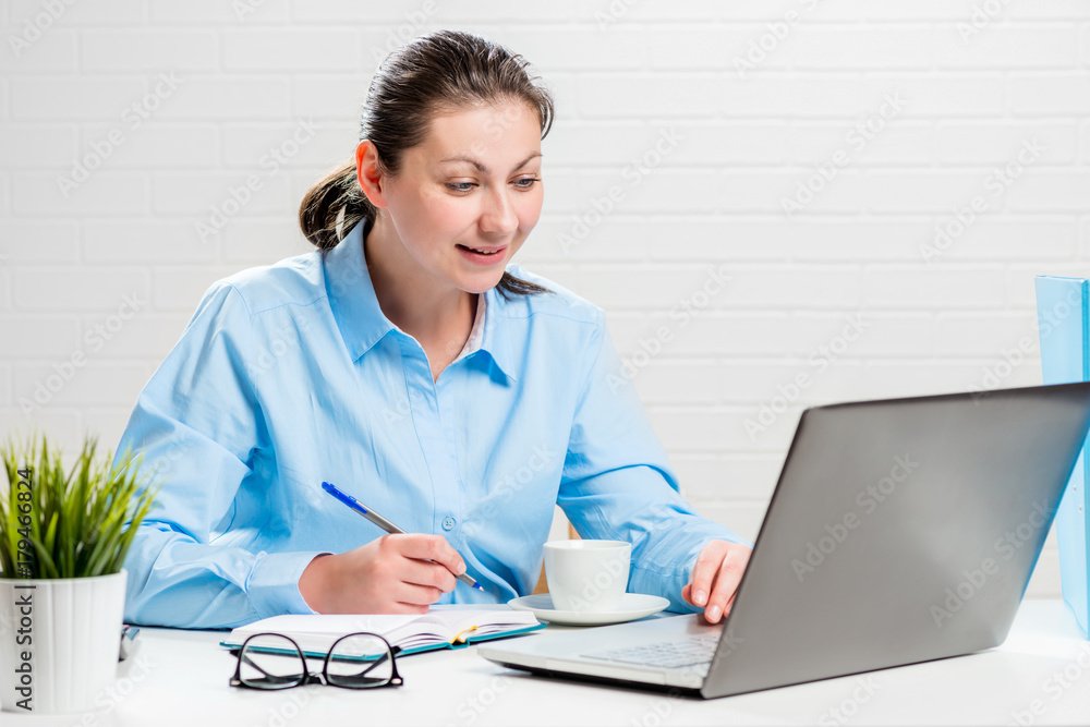 Secretary girl working in the office behind laptop Secretary girl working in the office behind laptop