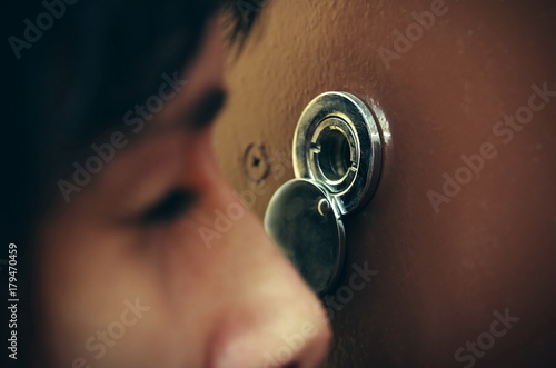 Fotografija Closeup of woman looking through peephole